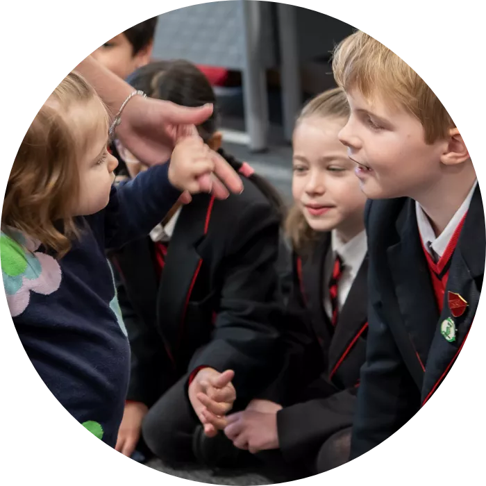 Young girl interacting with classroom of school children